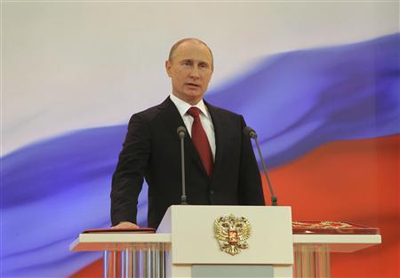 Putin wins back Kremlin as protests loom